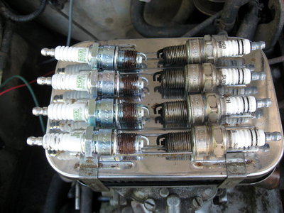 new and old spark plugs